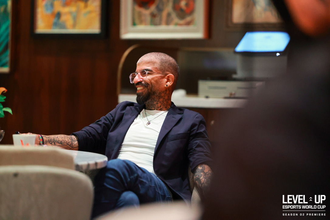 Tamer Azab seated and smiling at an event